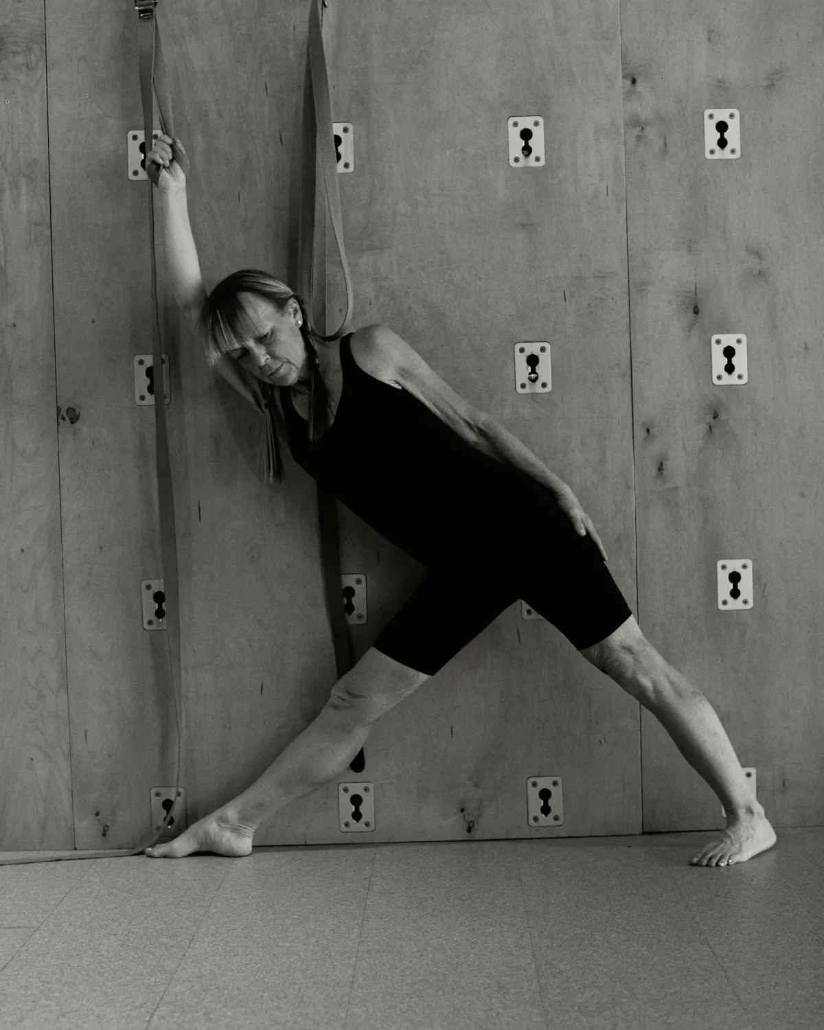 Woman practicing yoga with ropes
