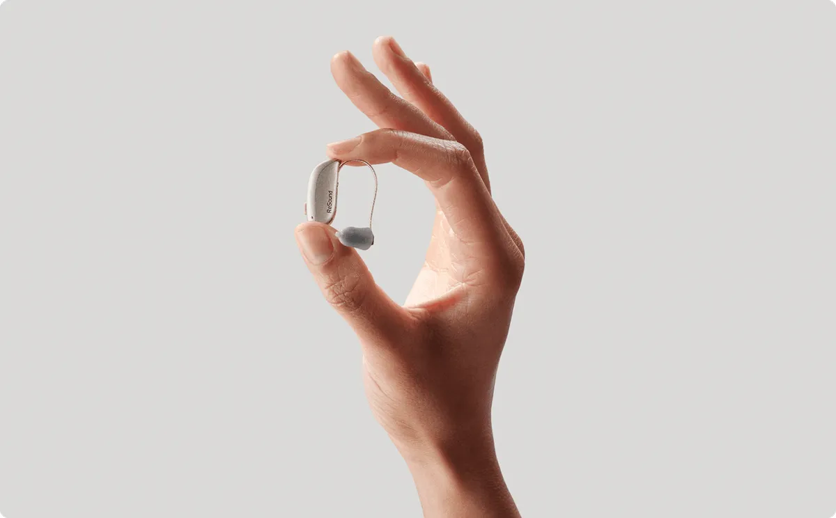 Hand holding ReSound Sensia hearing aid
