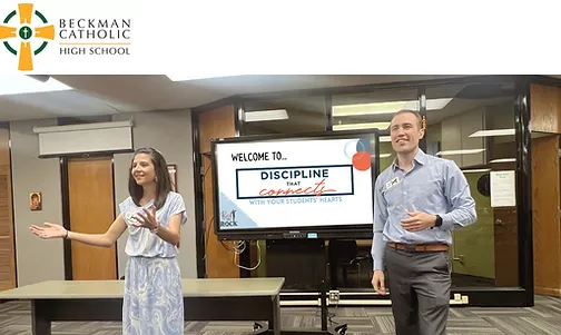 Parent coaches Luisa and Jarrett speaking at an event