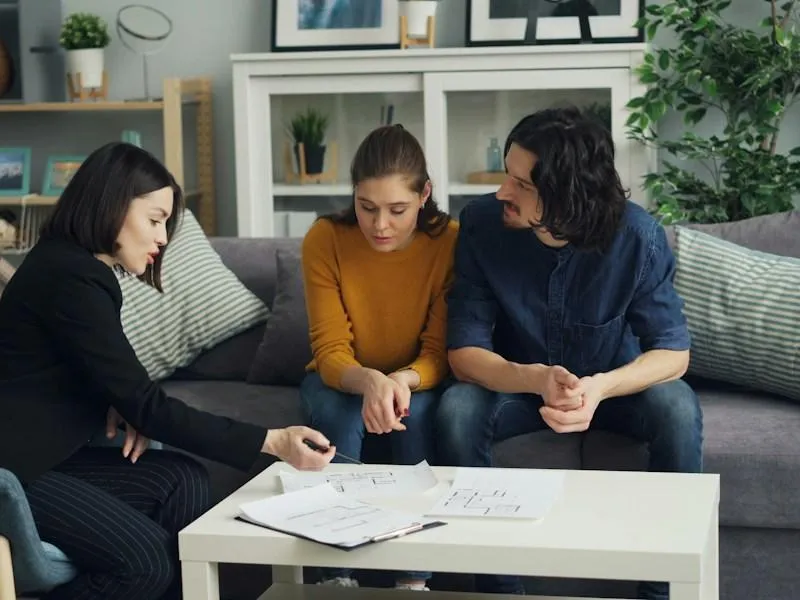 People sitting together talking through a home sale conversation