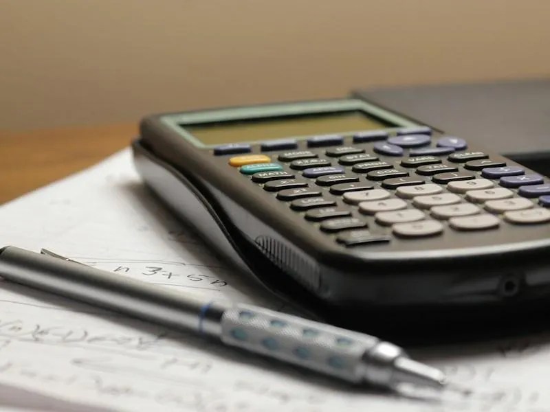 Fair, transparent cash offer calculation on a desk with a calculator, pen, and financial documents
