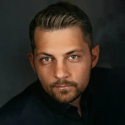 a man with a beard and a black shirt