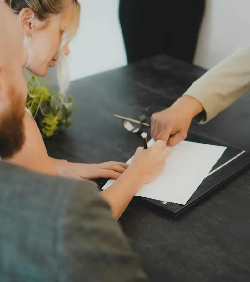 Centreville homeowner signing paperwork for a fast cash home sale