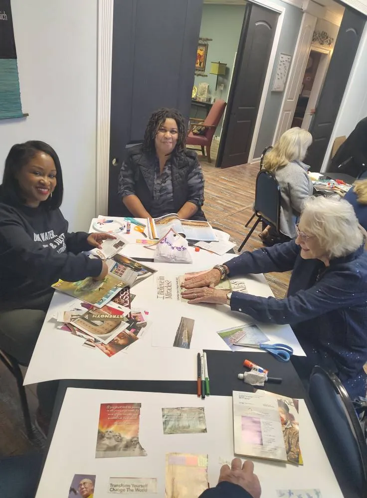 Creating Vision Boards - Members assembling vision boards at table