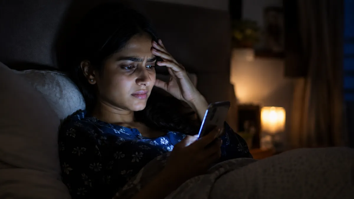 A person awake at night looking at a phone