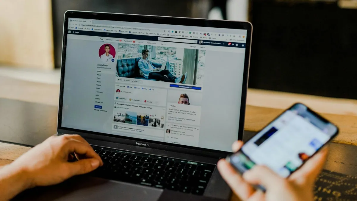 Contractor managing Meta Ads campaigns on laptop and smartphone