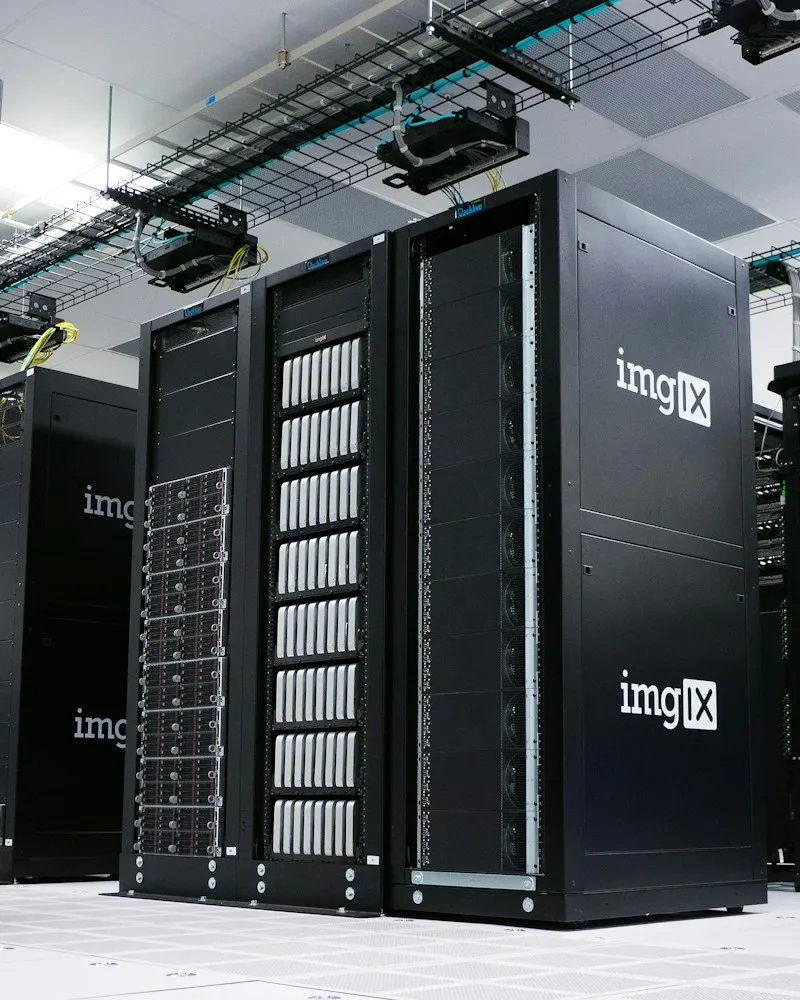 Rows of black server racks with white logos in a data center