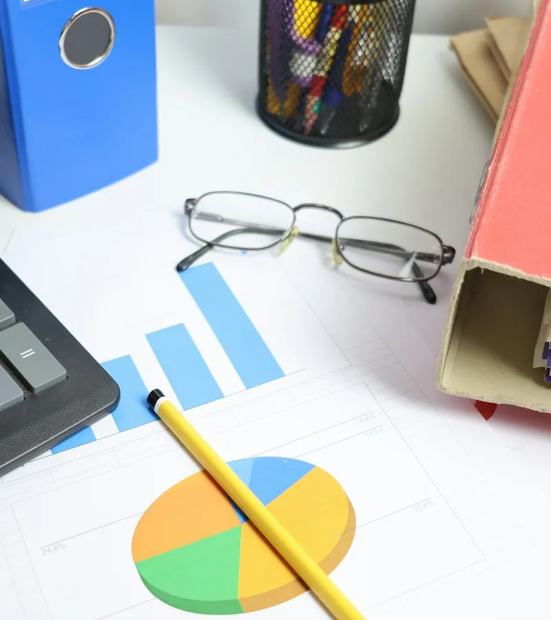 Financial consultation desk with notebook, glasses, and business credit planning tools