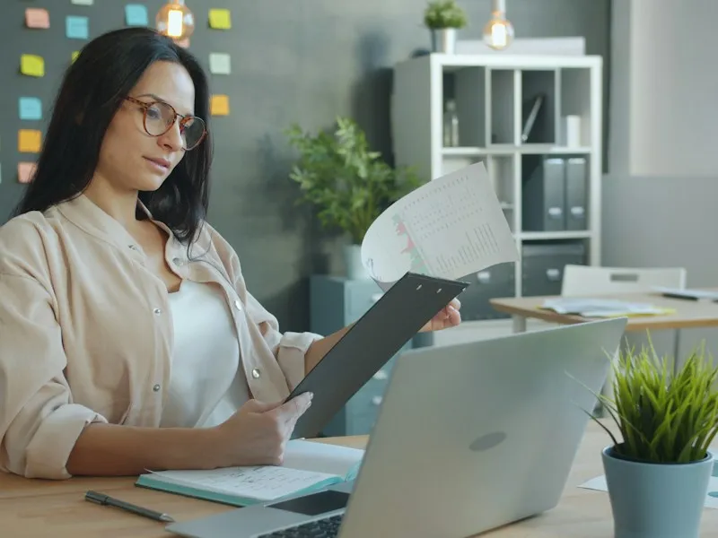 Small business owner reviewing funding documents at a desk