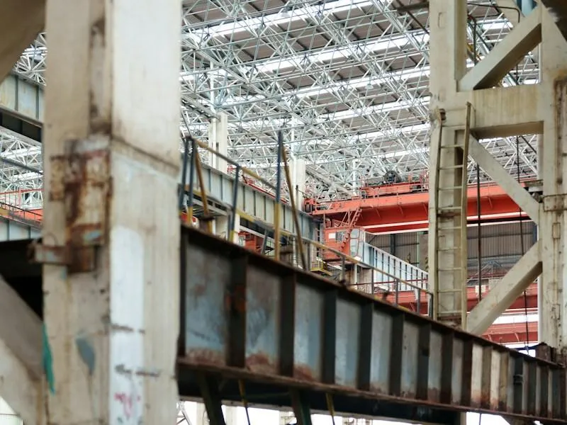Industrial interior with metal beams and an overhead crane