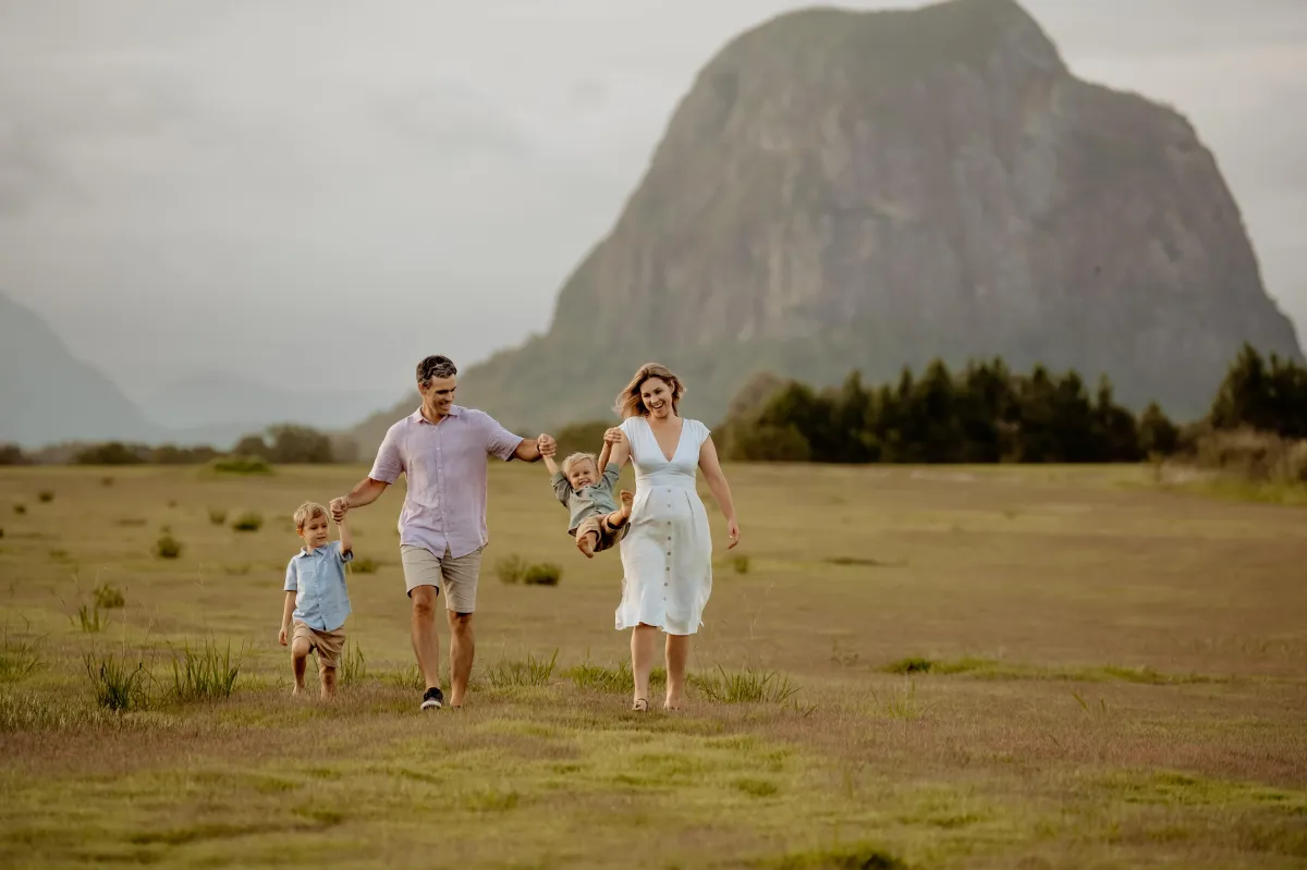 Bek Pozzoli's family walking together near the Glass House Mountains