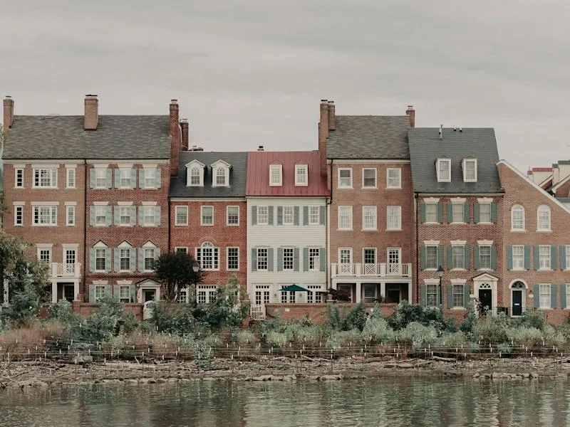Historic red and brown brick building beside the Potomac River in Old Town Alexandria