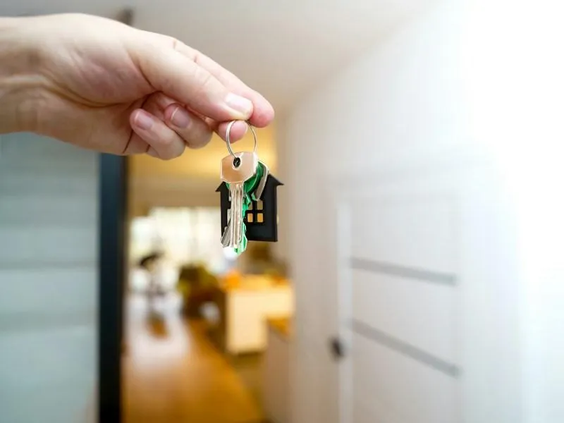 Holding house keys in front of the entrance