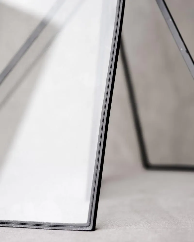 Abstract glass frames leaning against a backdrop