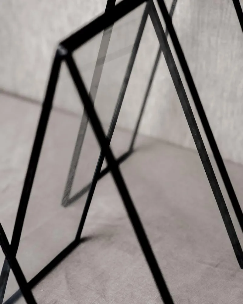 Geometric black frames leaning against a surface