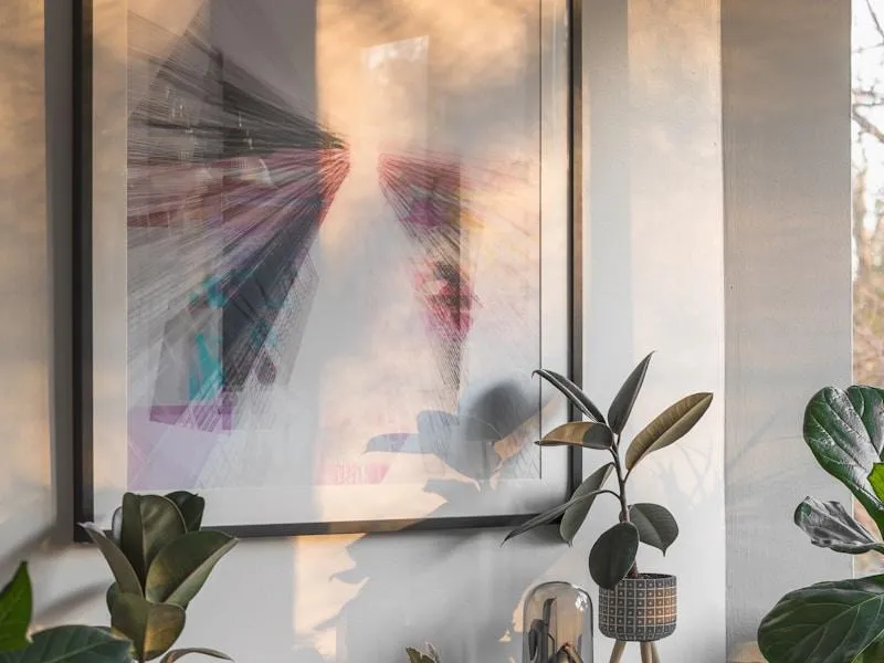 Framed fine art print of a green plant near a window