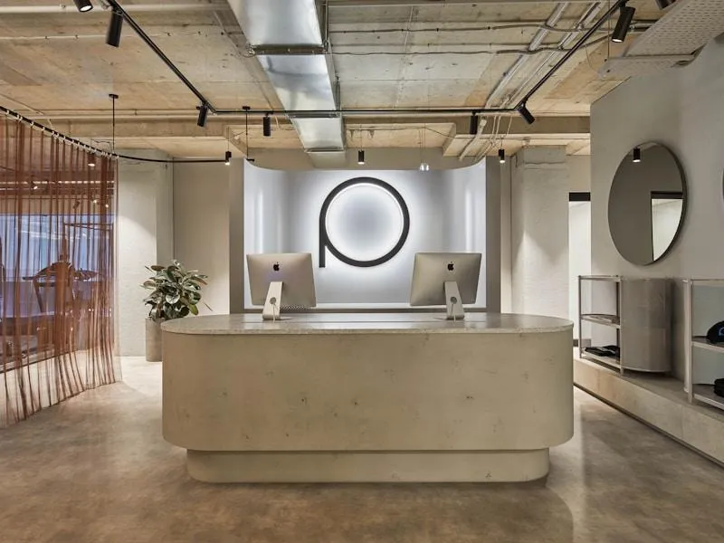 Modern reception desk with minimalist decor and logo