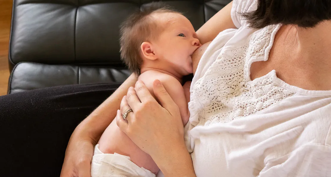 Mother holding baby on chest