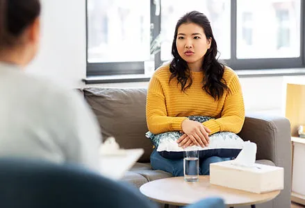 Therapist speaking with a client during a therapy session