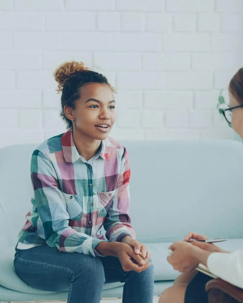 Two professionals talking in a modern office setting during a consultation