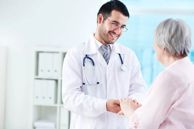 Physician in clinical setting discussing molecular testing and cancer care with a patient