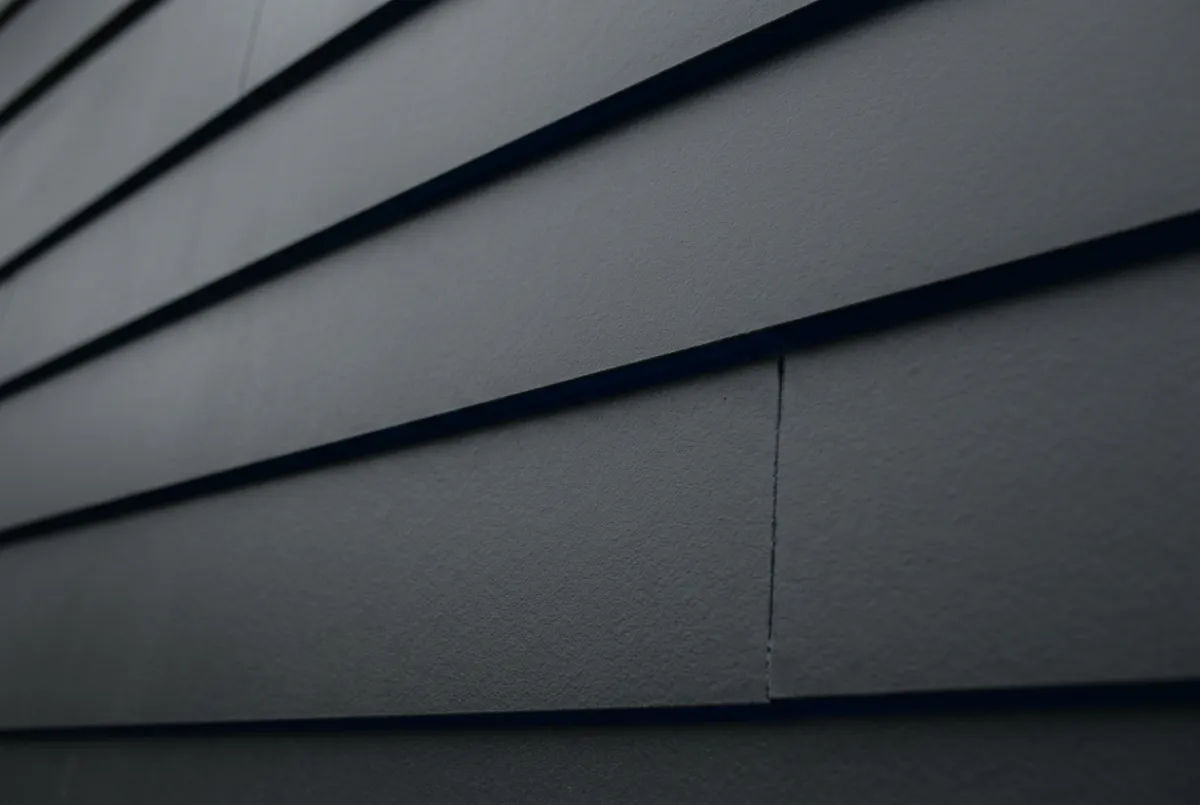 Siding repair and precision installation on home exterior facade