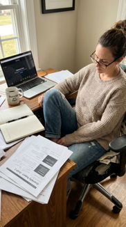 Woman sitting on floor working