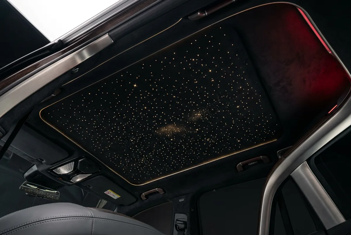 Luxury vehicle interior cabin fitted with custom fiber optic starlight headliner