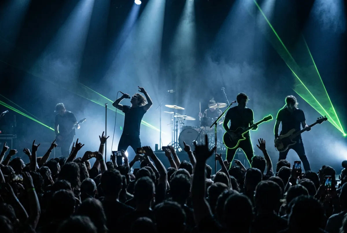 Live arena concert with dramatic stage lighting and energetic audience