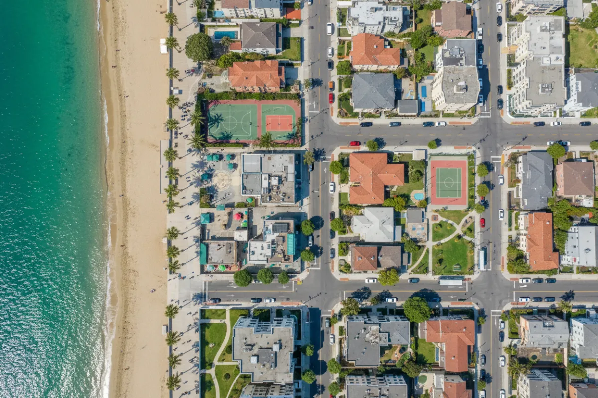 Aerial neighbourhood shot showing proximity to amenities and coastline.
