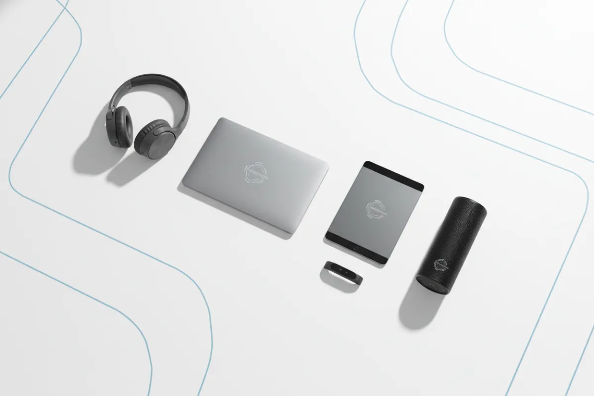 A flat lay arrangement of various refurbished tech products, including a laptop, tablet, smart speaker, and headphones, displayed on a clean white surface with subtle blue accents. The composition is modern and inviting, highlighting product quality and variety, with soft shadows and crisp, natural lighting.