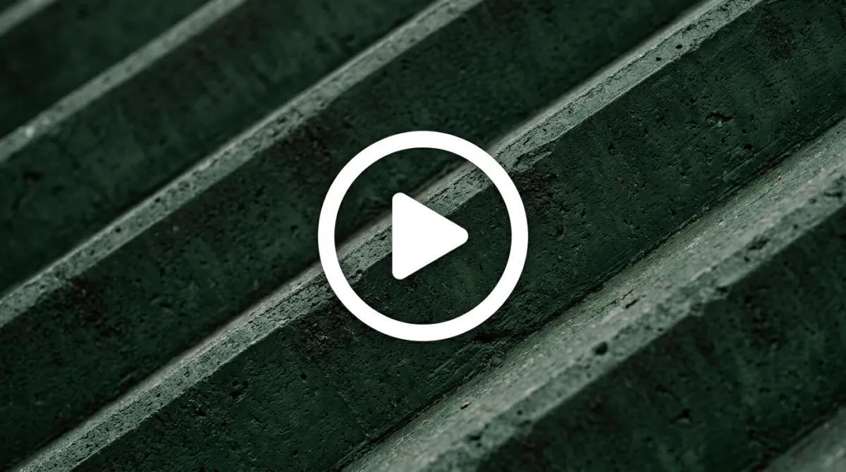 Abstract close-up of dark green diagonal concrete or stone steps with a white circle play icon overlaid in the center.