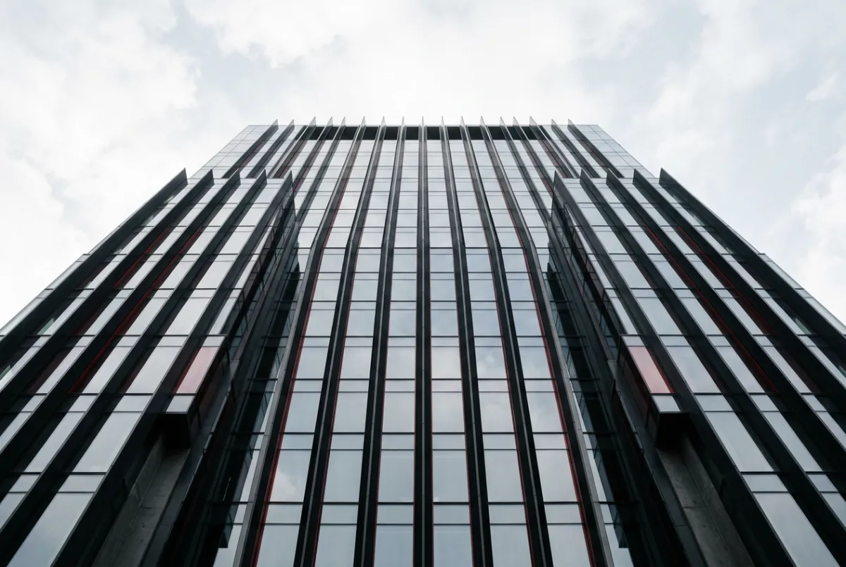 Monochrome architectural lines and structured glass facades representing systematic business development