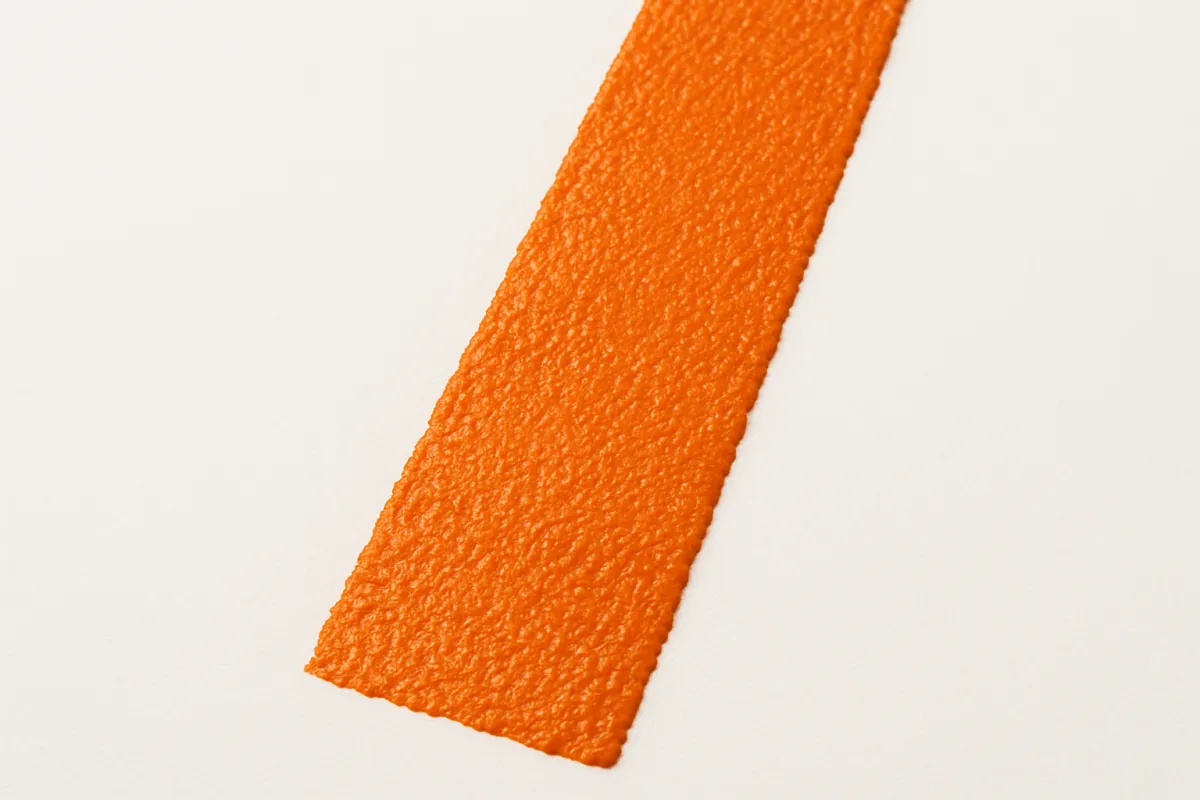 Close-up of freshly painted parking stall line with crisp edge detail.