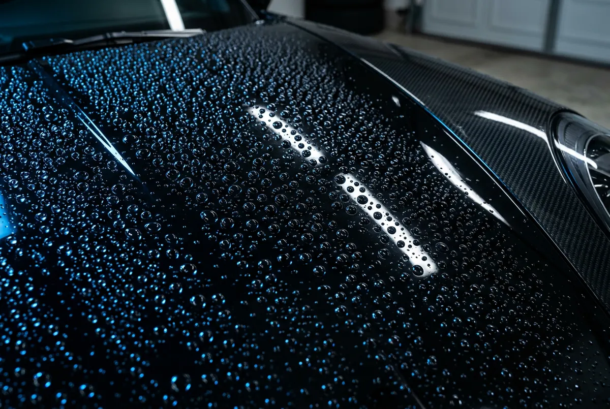 Hydrophobic ceramic coating deep gloss water beading on exotic sports car hood