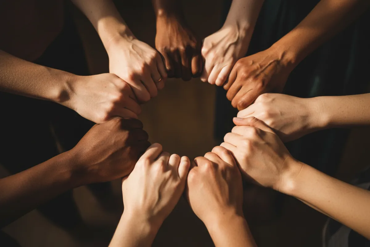 Group of diverse women's hands together in a circle