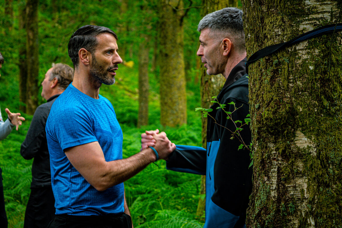 Paul Garrigan working with men in the forest