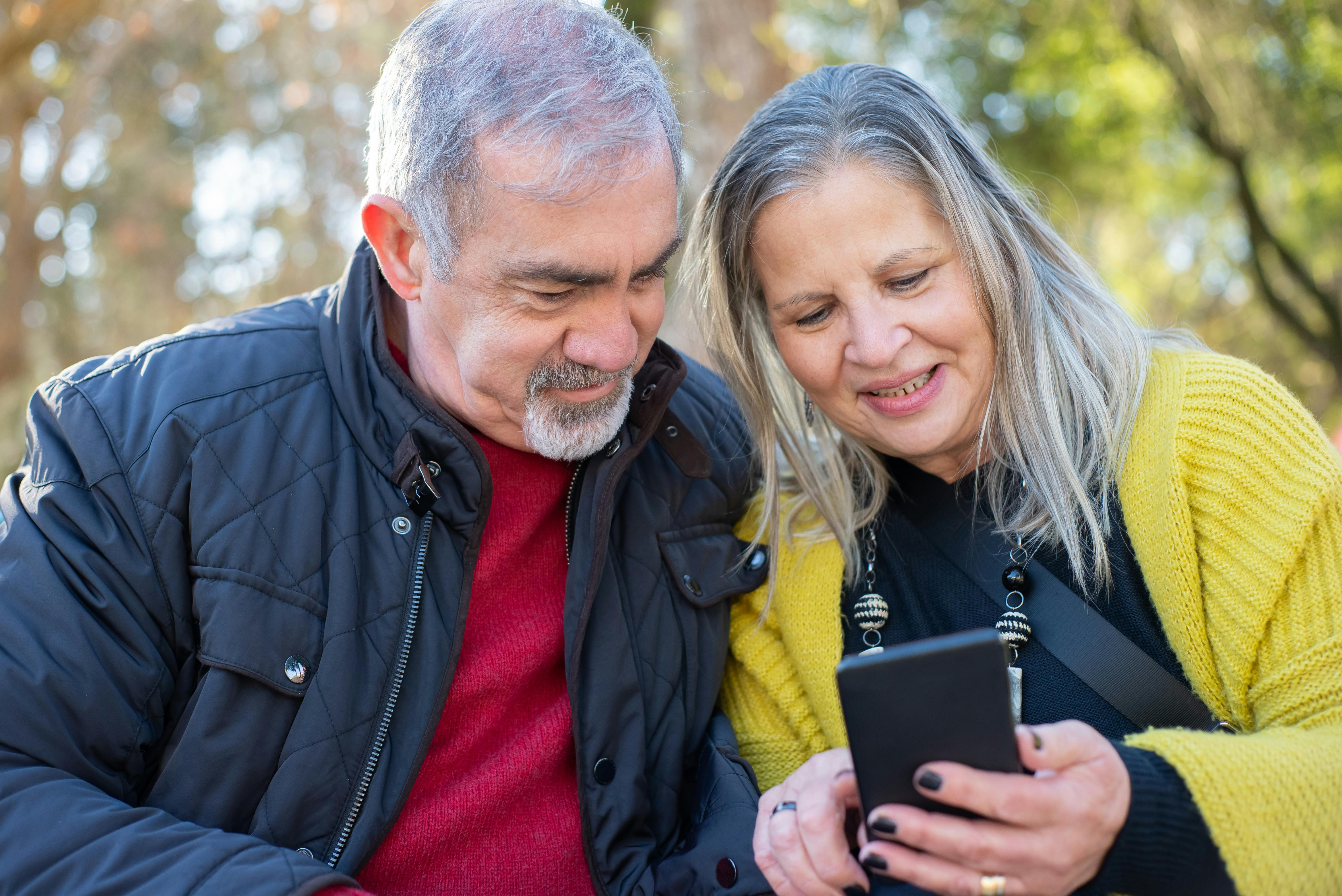 Elderly couple looking at phone