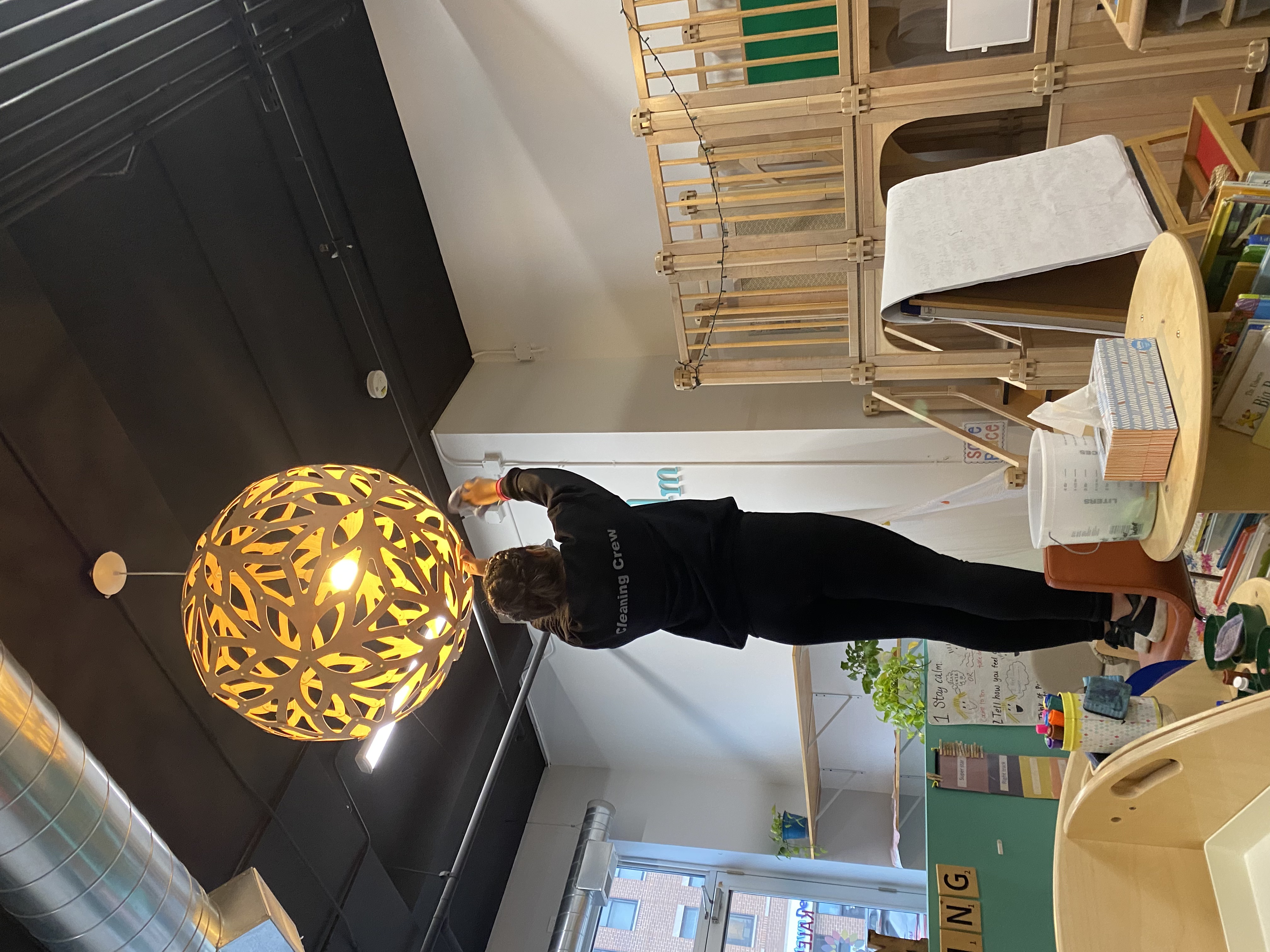 Cleaning crew member sanitizing