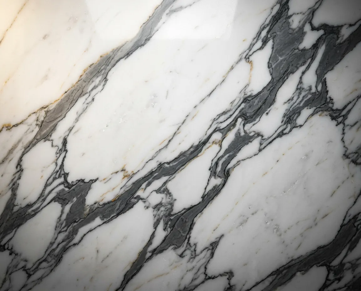 Macro texture close-up of Calacatta marble slab showing dramatic gold and charcoal veining