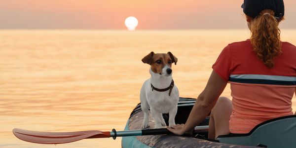 Woman with dog in kayak