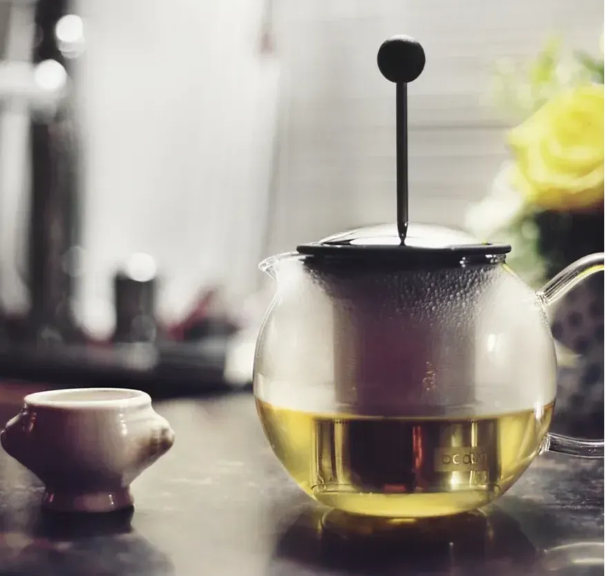Image of a tea pot and cup in calming tones and muted colors