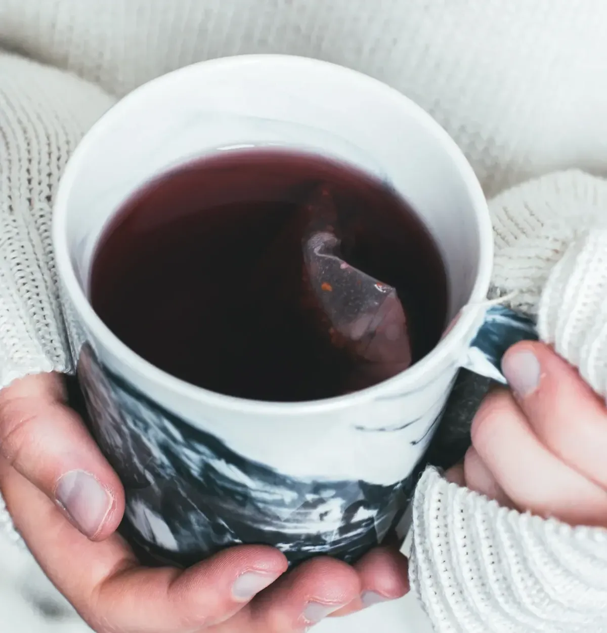 Person holding a mug of tea