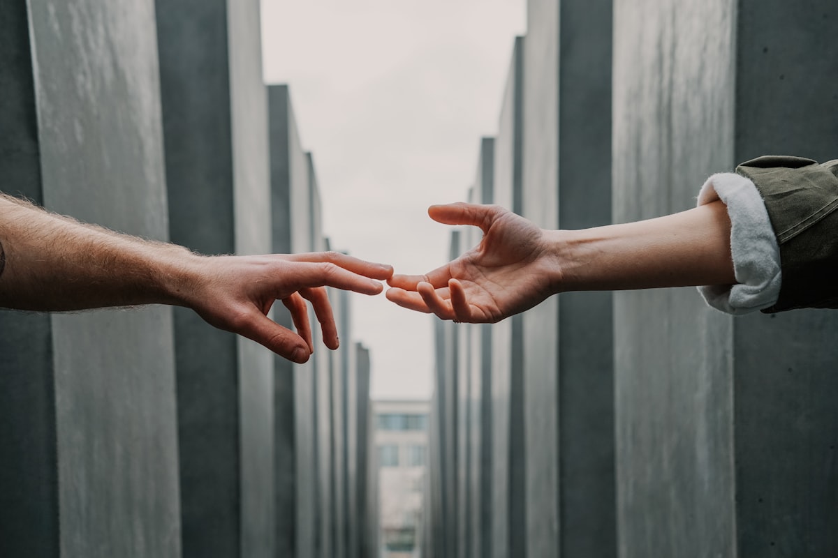 Hands reaching out to hold each other