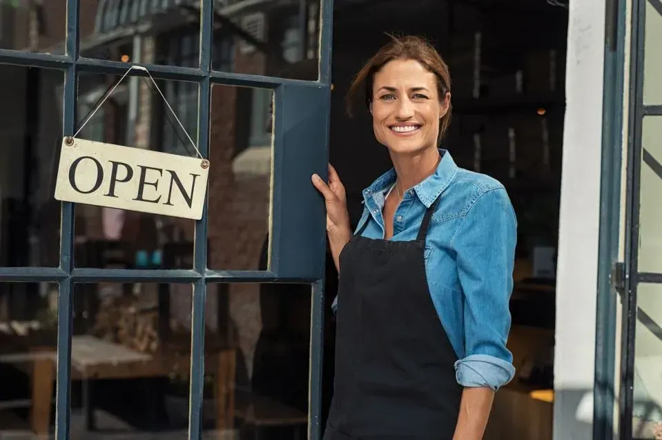 Woman business owner opening her restaurant, representing business insurance coverage from We Insure Downtown Miami.