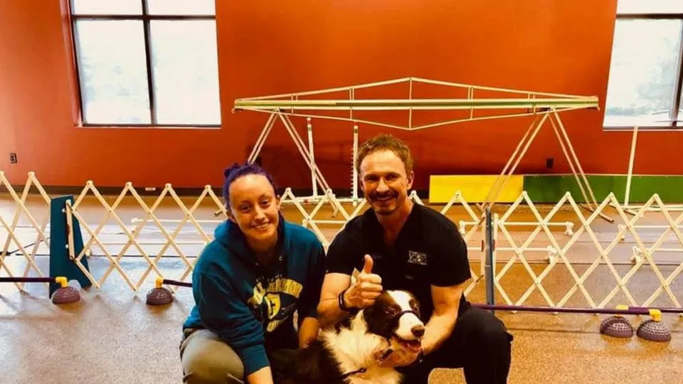 People and dog in an agility course