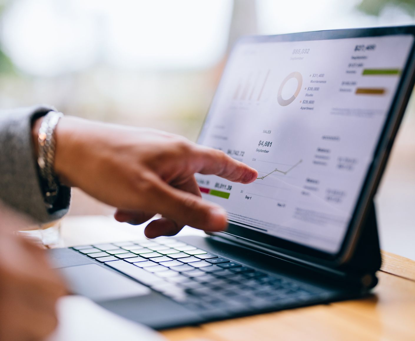 Person analyzing charts on laptop