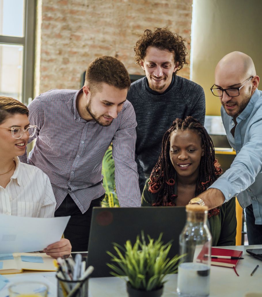 Team of IT professionals collaborating over a laptop
