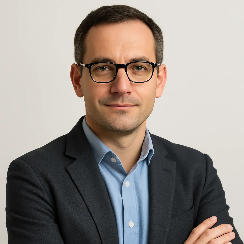 Portrait of the founder — confident mid-40s engineer, head-and-shoulders studio headshot.