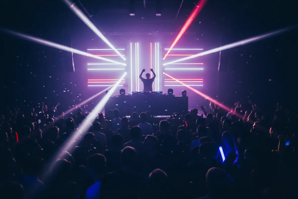 DJ booth with dynamic LED lighting over a packed dance floor